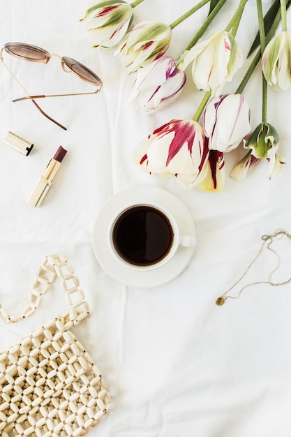 Fashion beauty blog composition. Tulip flowers bouquet, coffee cup, accessories