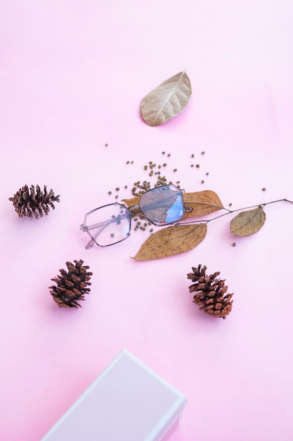 Fashion and beauty concept lying flat with square glasses women's accessories on pink background Product Presentation of Minimalist Concept Ideas