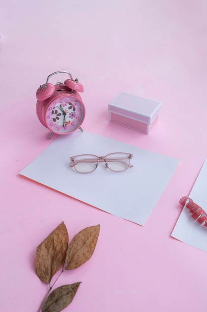 Fashion and beauty concept lying flat with square glasses women's accessories on pink background