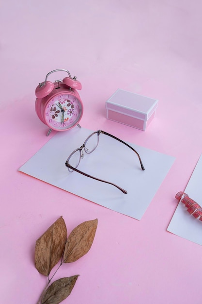 Fashion and beauty concept lying flat with square glasses women's accessories on pink background