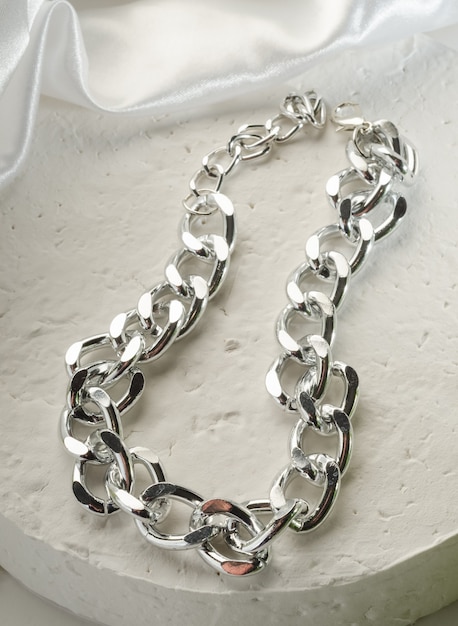 Fashion bijouterie - large silver chain bracelet on a white stand