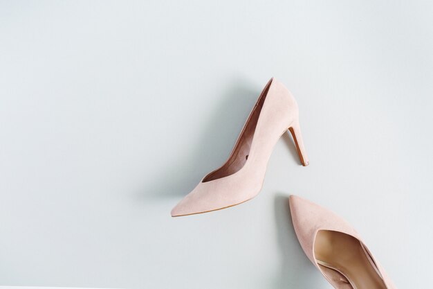 Fashion blog look. Pale pink women high heel shoes on blue