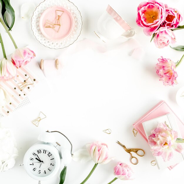 Photo fashion blog pink style desk with accessories tulip flowers scissors coffee cup on white background