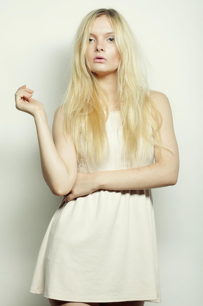 Photo fashion blond woman in white dress posing in studio