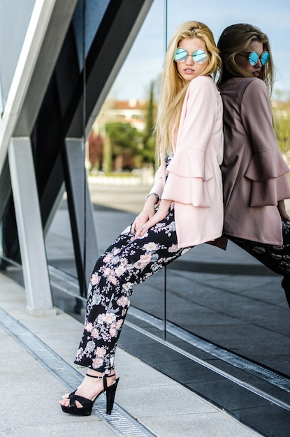 Fashion blonde model posing at the street