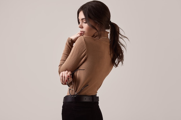 Fashion brunette woman wearing turtleneck