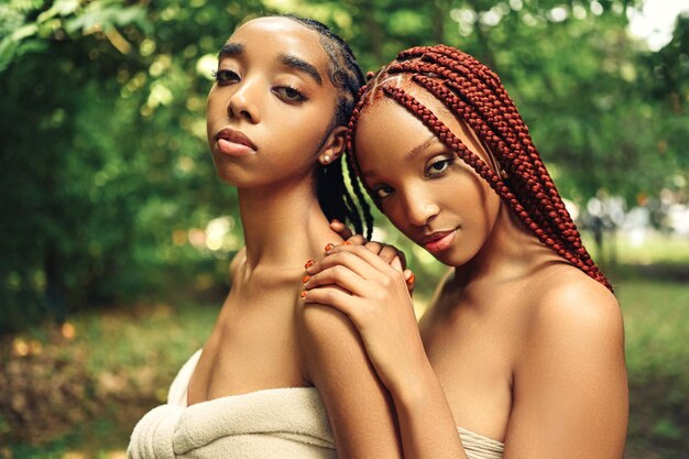 Fashion close up outdoor portrait beautiful young african american female couple with braids hair