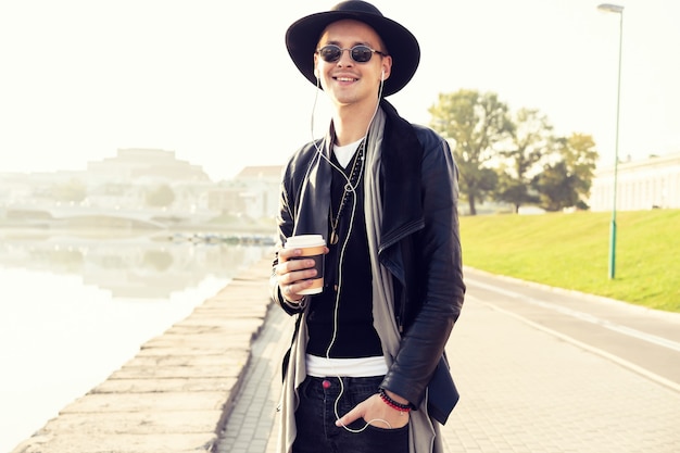 Fashion, clothes and people concept - stylish handsome man in trendy outfit with sunglasses