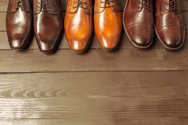 Fashion concept with male shoes on wood