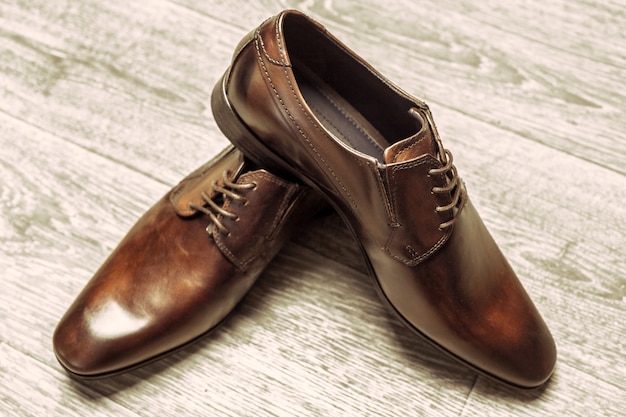 Fashion concept with male shoes on wooden background