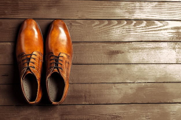 Fashion concept with male shoes on wooden background