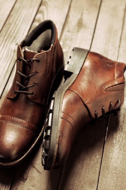 Fashion concept with male shoes on wooden 