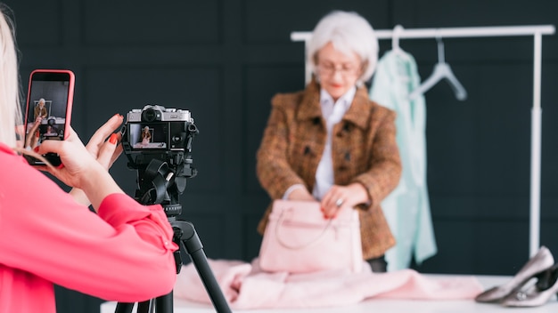 fashion consultant in showroom. senior trendy woman. personal stylist at work