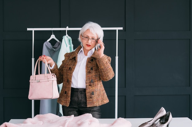 Fashion consultant in showroom. senior trendy woman. personal stylist at work