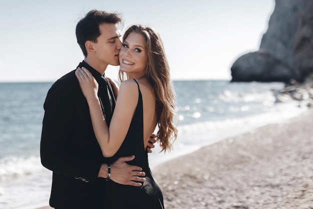 Photo fashion couple in black dress and suit outdoor