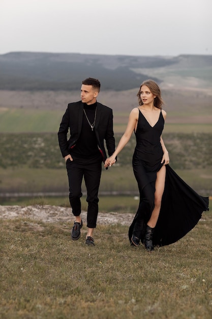 fashion couple in black dress and suit