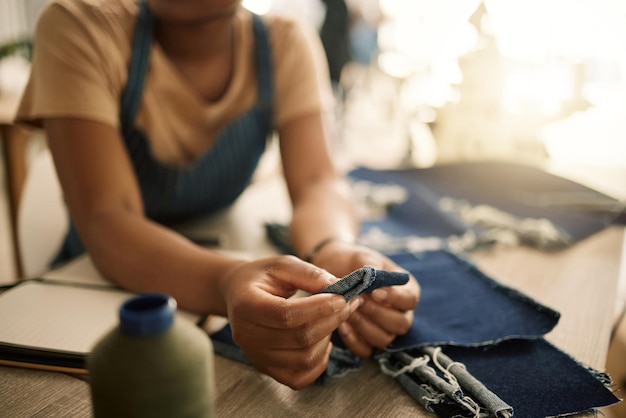 Fashion design student sewing learning and making creative denim clothes in a clothing manufacturing factory Industry artistic and fashionable designer busy in a workshop working on stylish jeans