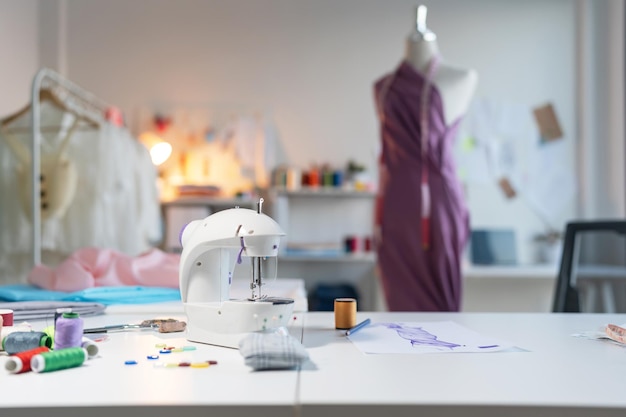 Photo fashion design studio workplace with sew manikins