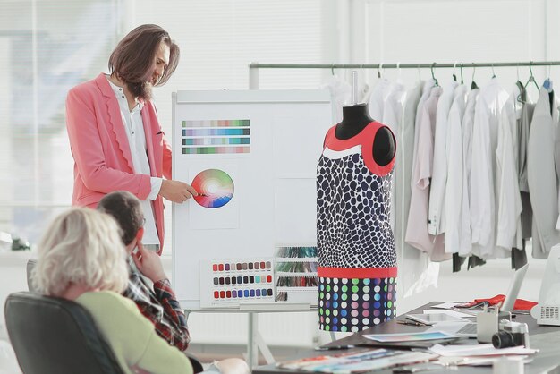 Fashion designer discusses with colleagues fabric samples