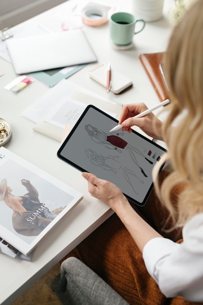 Fashion designer drawing on a digital tablet