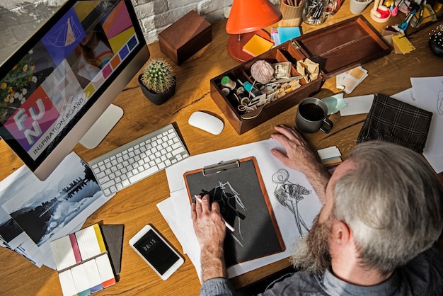 Fashion designer drawing, working in a studio