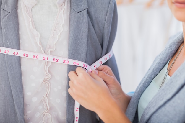 Photo fashion designer measuring blazer