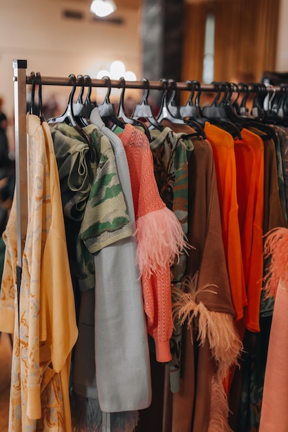 Fashion designer outfits hanging in a row at the backstage fashion week