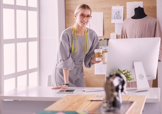 Fashion designer woman sewing with sewing machine