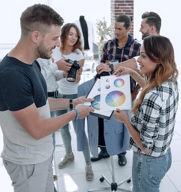 Fashion designers discussing color palette in the studio