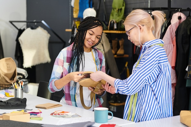 Fashion designers sewing bags