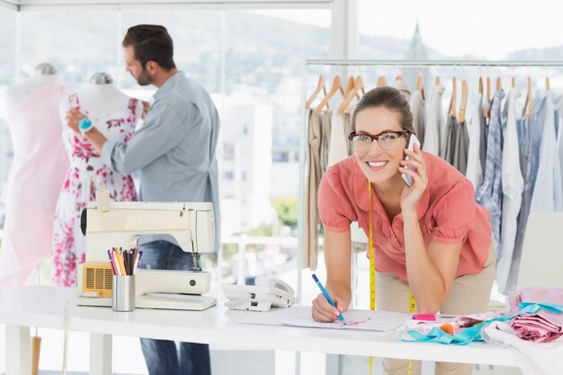 Fashion designers at work in bright studio