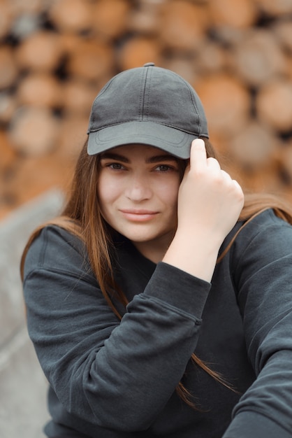 Moda donna elegante che indossa una giacca nera e un cappello nero.