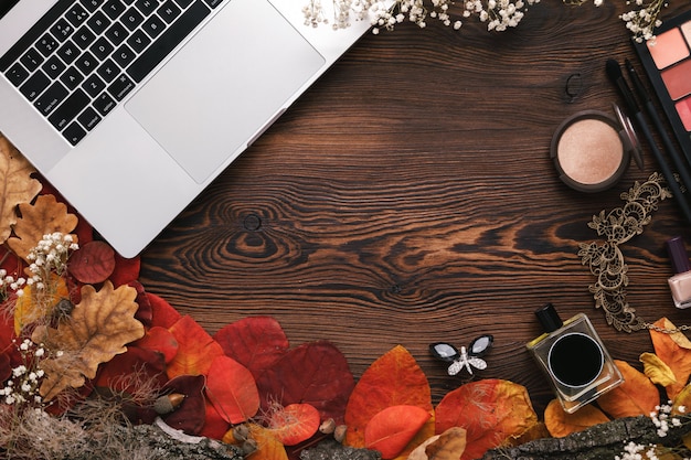 fashion female accessories set. autumn leaves and laptop