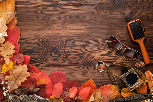fashion female accessories set. autumn leaves, sunglasses, perfume and jewelry