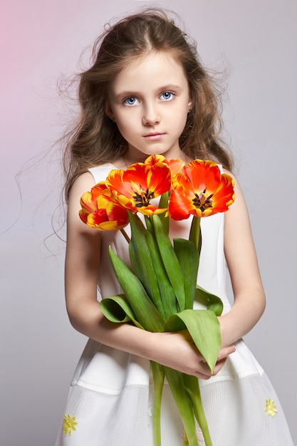 Fashion girl with tulips in hands, back to school