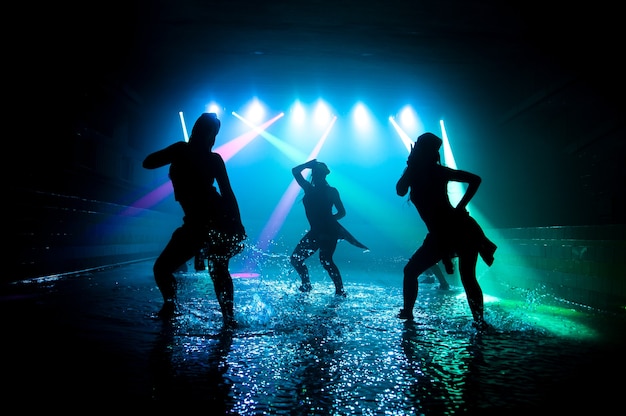 Fashion girls dancing on the water