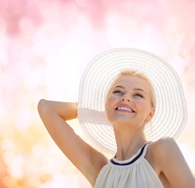 fashion, happiness and lifestyle concept - beautiful woman in hat enjoying summer outdoors