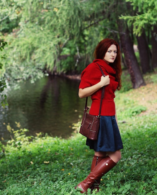 Fashion happy woman near the river