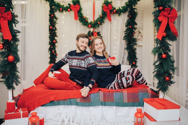 Fashion interior holiday christmas photo of beautiful tender couple