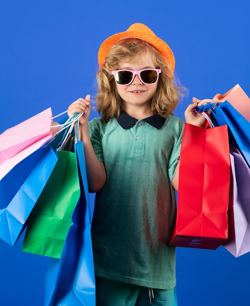 Fashion kid with shopping bag in studio Little shopper child