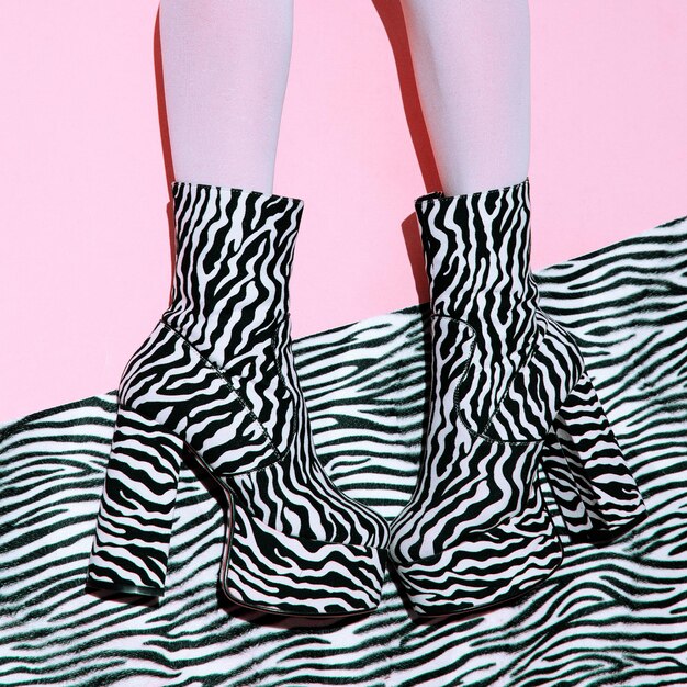 Fashion legs in heel party zebra boots on minimal pink