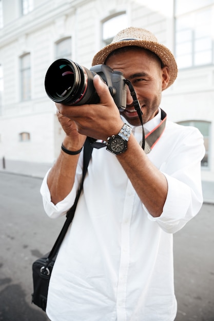 Uomo di moda con la macchina fotografica in strada