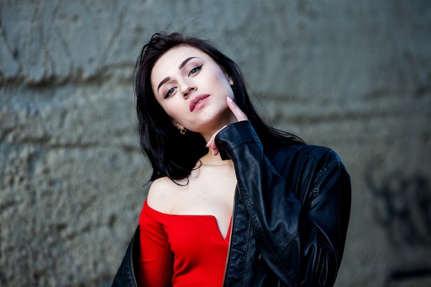 Fashion model in black leather jacket posing outdoor