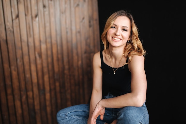 Fashion model in denim and black t-shirt in studio