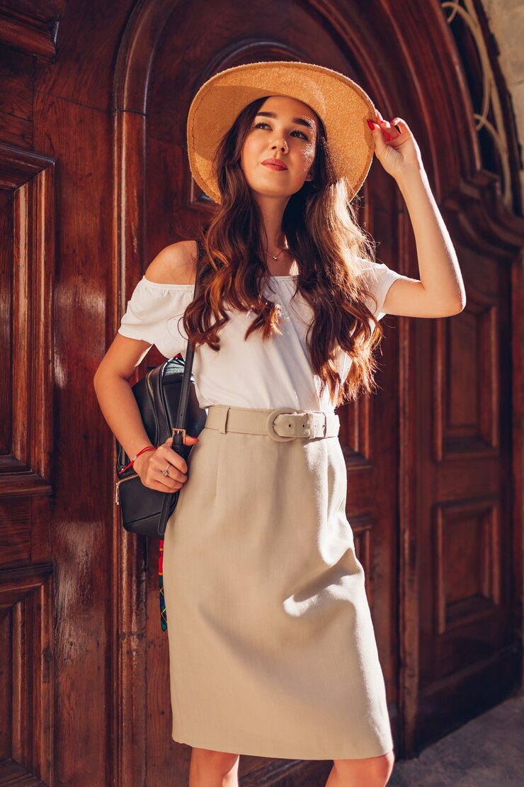 Photo fashion model. outdoor portrait of young beautiful woman wearing straw hat and holding backpack.