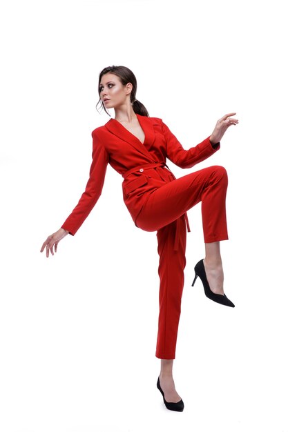 Fashion model in red suit jacket pants on a white background Studio shot