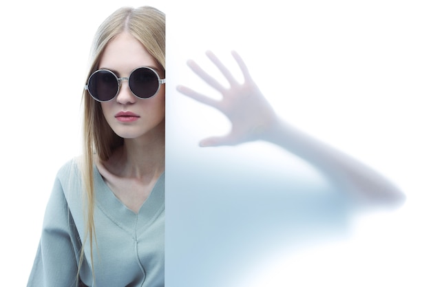 Fashion model in sunglasses, beautiful young woman. Studio shot