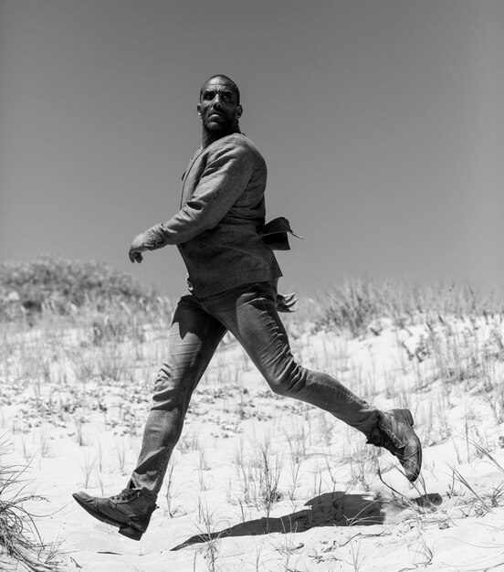 Fashion model walking in the dunes