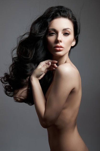 fashion nude woman posing with long hair