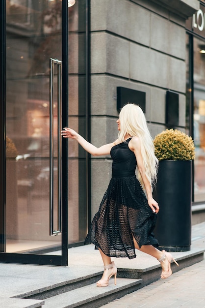 fashion outdoor portrait of beautiful blond girl on street.